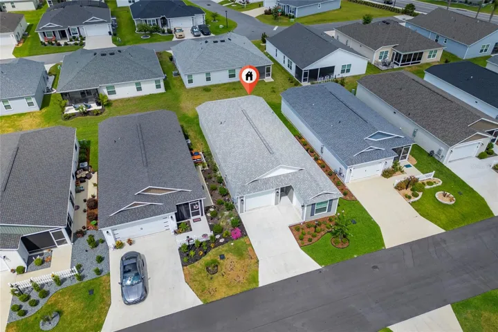 Alternate aerial property view with roofline and home marker.