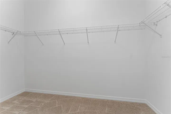 Walk-in closet in the primary suite.