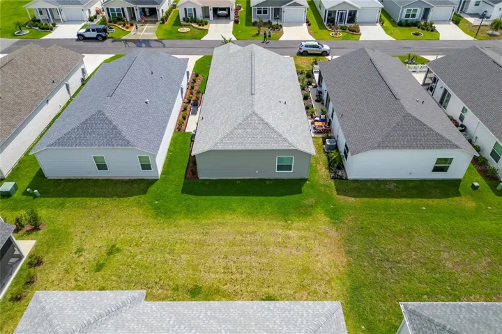 Aerial view of the backyard and rear exterior.