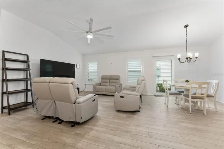 Combined living and dining space with luxury vinyl plank flooring.