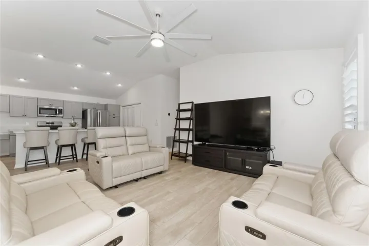 Open living room and kitchen layout with volume ceiling feel.