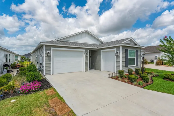 Front exterior showing the 1-car garage and separate golf cart garage.