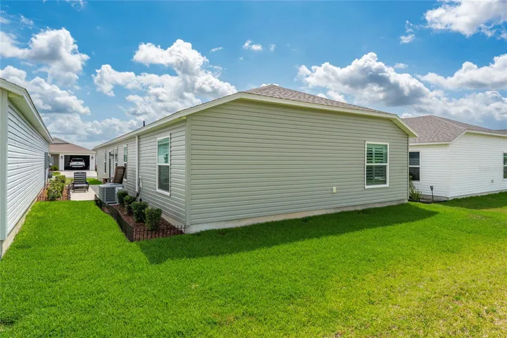 Rear exterior showing the backyard and bedroom window line.