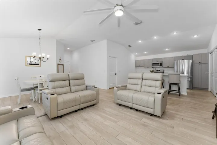 Bright, airy Emerald IV open floor plan connecting the kitchen, dining area, and living room.