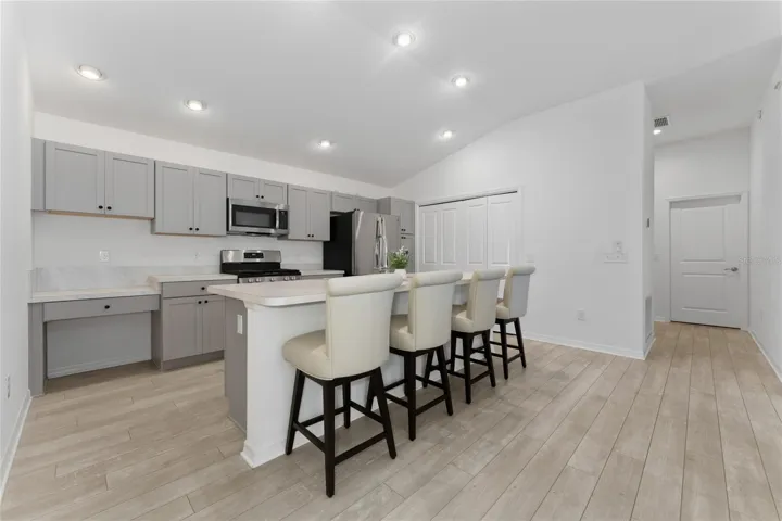 Kitchen with oversized island, counter seating, and lower planning counter.