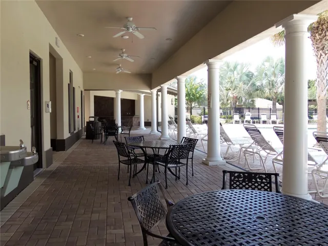 Shady Tabled by Pool and Entrance to Fitness Room