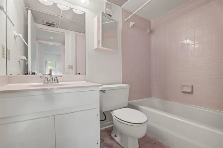 Secondary bathroom with single vanity and tub/shower combo.