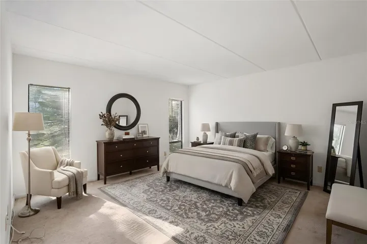 Spacious Primary Suite. Natural light and generous dimensions create a comfortable bedroom with plenty of room to arrange furniture to suit your style. Virtually stged photo.