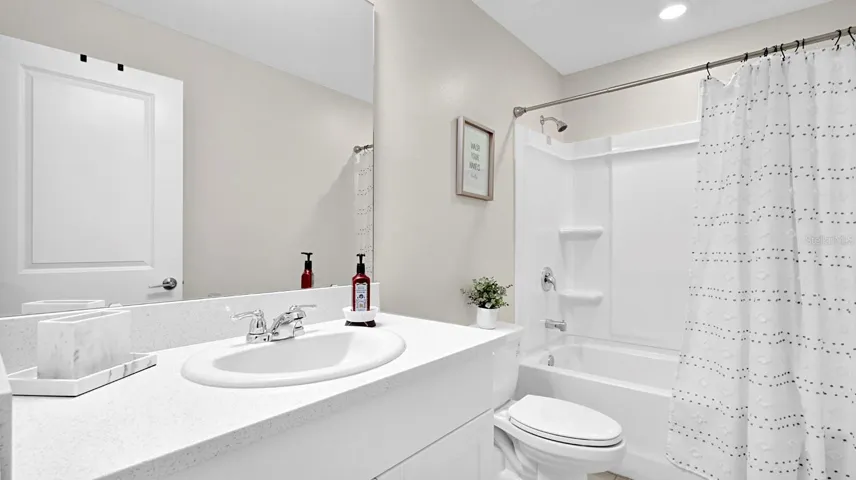 Full Bathroom. Second Floor. Shower/Tub Combo. Tile Flooring. Solid Surface Counter