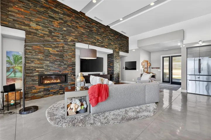 Concrete Flooring, Stacked Stone Wall,  Cozy Fireplace