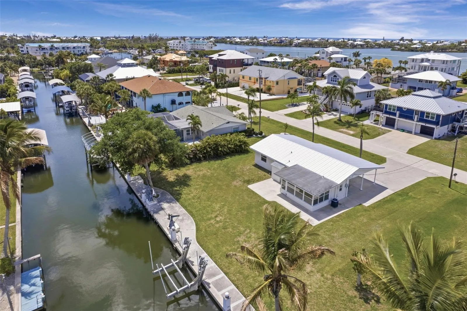 Back of home and saltwater canal with boat lift. . Facing Southwest.