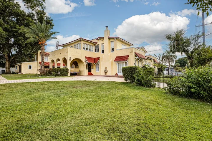 Expansive side lawn showcases the homes impressive scale