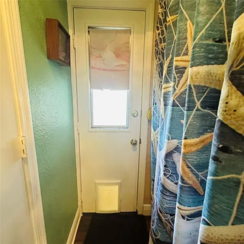 exterior door in bathroom to pool cage