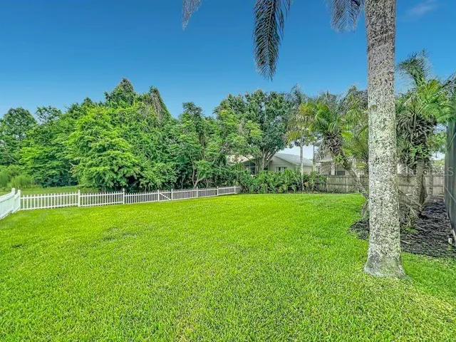 Fenced large backyard overlooking pond and conversation area