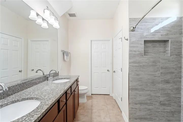 Remodeled Primary EnSuite Shower with Linen closet and Spacious Walk-in Closet.