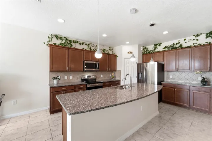 Tile Backsplash and granite countertops, wood Cabinets with crown molding.