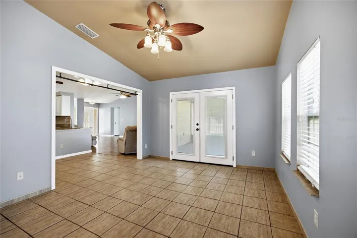 Florida Room opposite direction with entrance to screened porch and pool