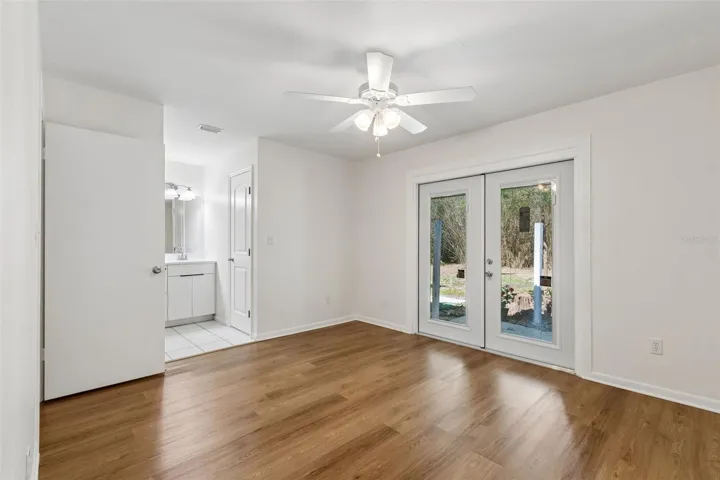 Primary bedroom with French doors leading to a patio