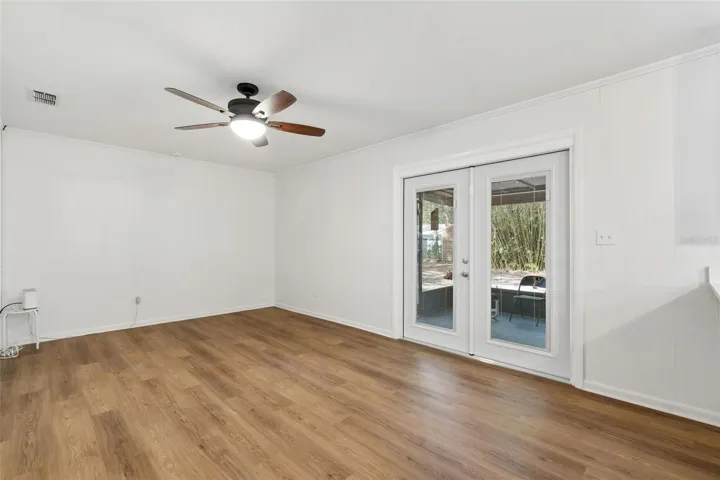 Family room with new French doors with blinds between the glass