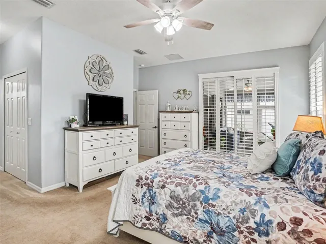 Primary Bedroom with access to Lanai.  Rolling Plantation Shutters