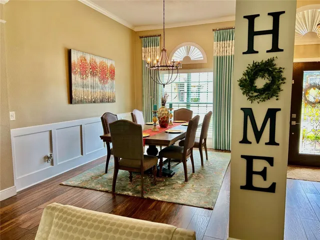 Custom board and batten wainscoting adds timeless architectural character to the dining room.