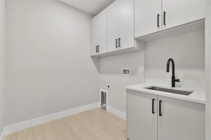 Large laundry room with built in sink
