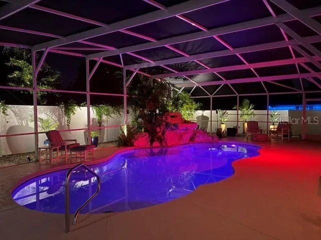 Illuminated pool with decorative landscape lighting