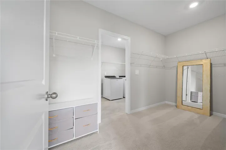 Primary closet leading to laundry room
