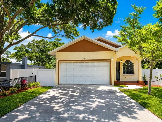 Front Exterior – Charming single-family home with attached 2-car garage, extended driveway, and fully fenced yard.