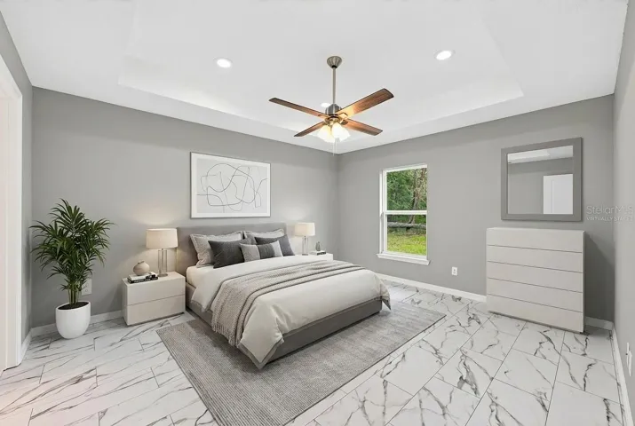 The Primary Suite provides a relaxing retreat, featuring a dramatic tray ceiling, walk-in closet, and a LUXURIOUS EN SUITE BATH. Virtually Staged