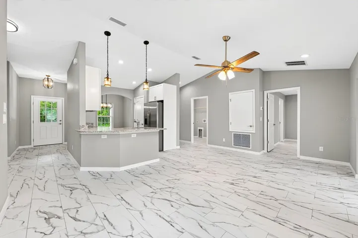 The Kitchen and Living Room's OPEN-CONCEPT LAYOUT creates an inviting space for both entertaining and everyday living.