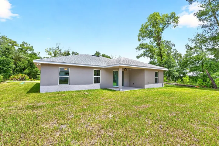 Step outside to the covered patio and take in the EXPANSIVE BACKYARD.