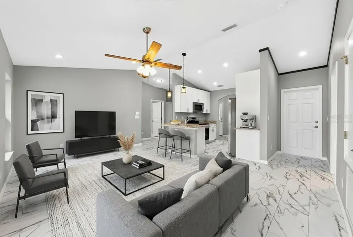 The Kitchen overlooks the spacious Living Room where you'll enjoy a sleek ceiling fan, ABUNDANT NATURAL LIGHT, and sliding glass doors that open to the covered patio. Virtually Staged