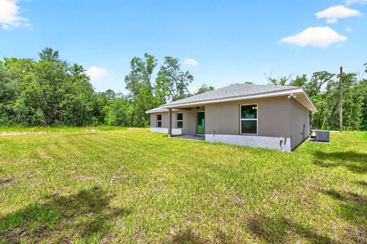 The expansive backyard offers endless possibilities for outdoor living, gardening, recreation, or simply enjoying the peaceful surroundings and wide-open space.