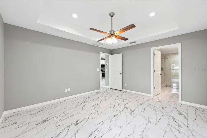 The Primary Suite provides a relaxing retreat, featuring a dramatic tray ceiling, walk-in closet, and a LUXURIOUS EN SUITE BATH.