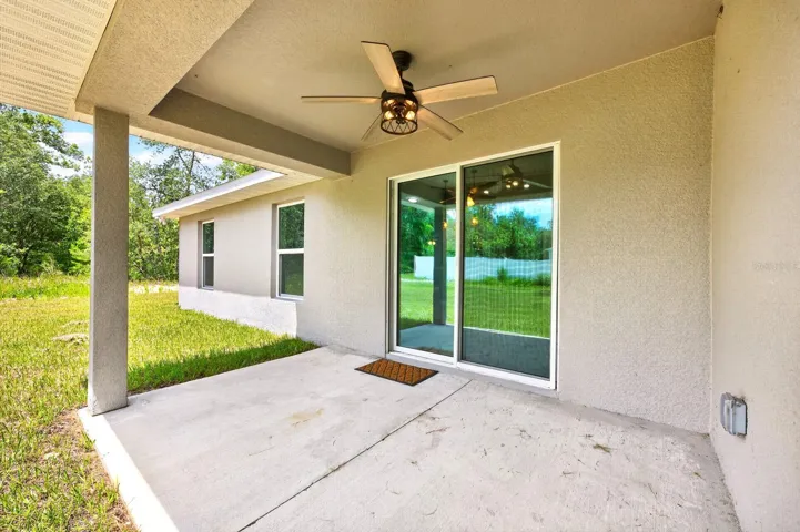 Step outside to the covered patio and take in the EXPANSIVE BACKYARD.