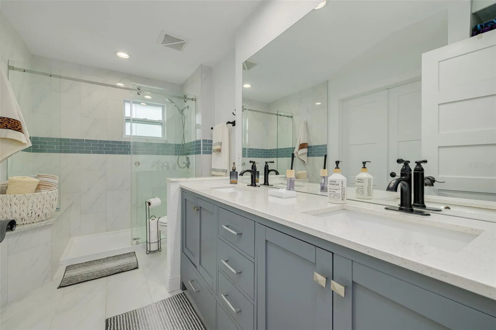 Remodeled bathroom with double-sink vanity and a spacious walk-in shower