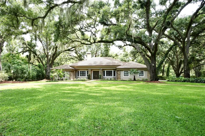 ONE-OWNER Custom Home with STEEL CONSTRUCTION AND STEEL TRUSSES situated on a beautifully landscaped ONE-ACRE homesite.