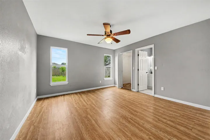 A comfortable primary retreat with low-maintenance flooring, spacious walk-in closet, ensuite bathroom, and plenty of natural light.
