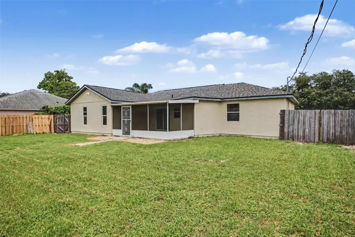 The oversized fenced backyard offers room for pets, play, gardening, and outdoor fun.
