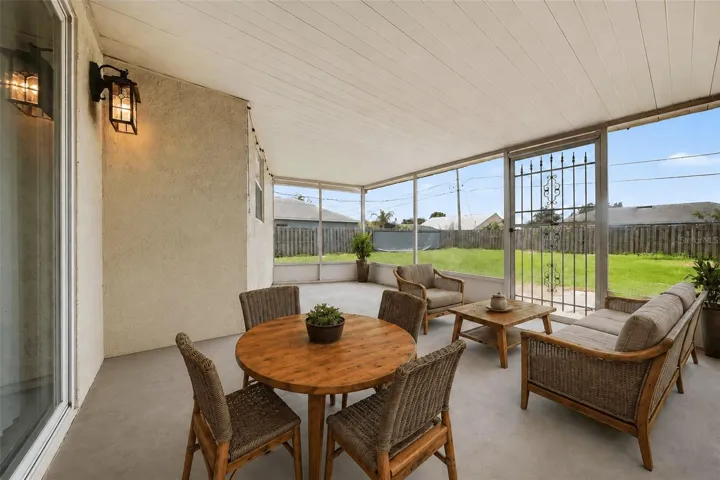 Extended living space is achieved with this screened patio  -  ideal for relaxing, dining, or enjoying Florida living without the bugs.