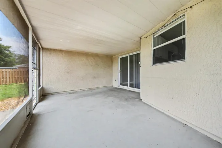 Extended living space is achieved with this screened patio  -  ideal for relaxing, dining, or enjoying Florida living without the bugs.