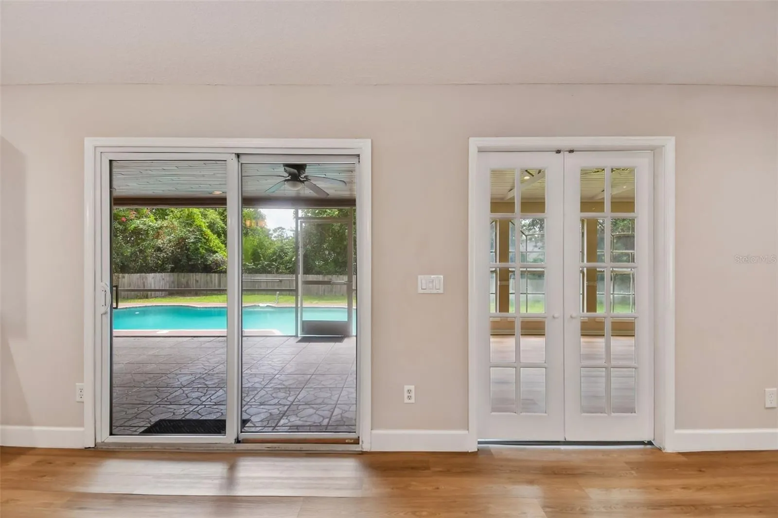 Great Room overlooking enclosed Bonus Room, Enclosed Porch, and Pool.