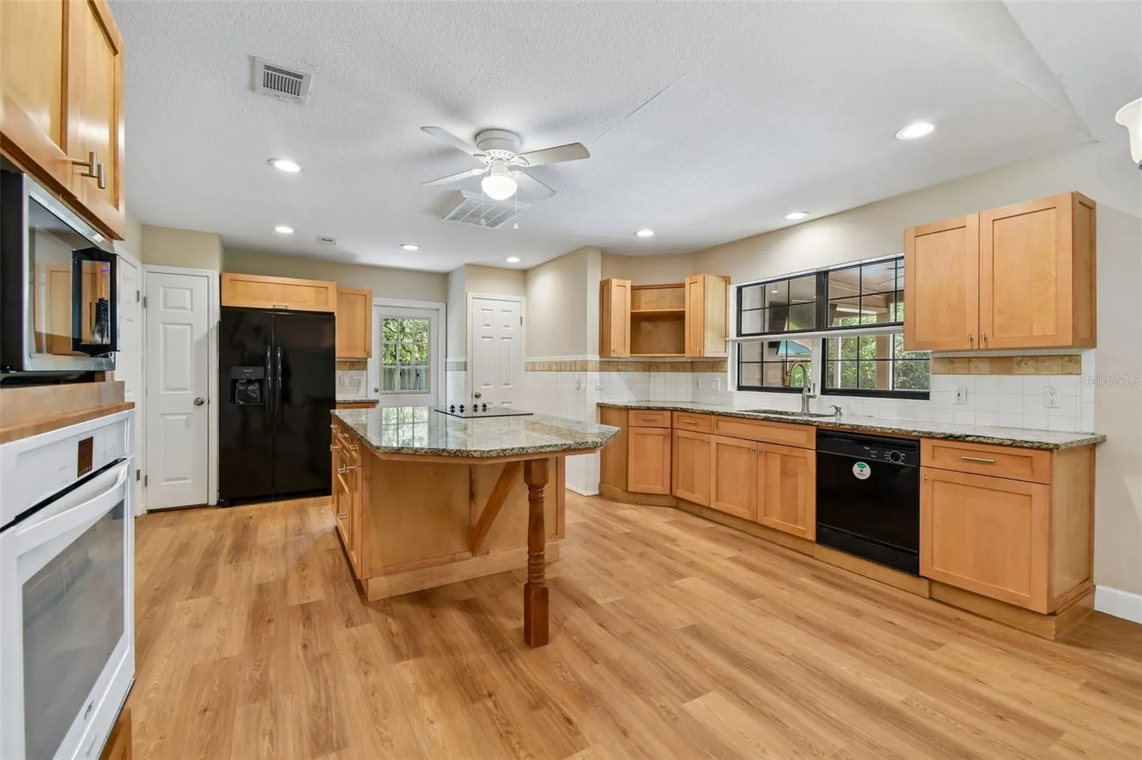 Open and large Kitchen with Granite Countertops, Cooktop,  Recessed Lighting, Oven, Eat In, Islandm and 3 Pantry Closets