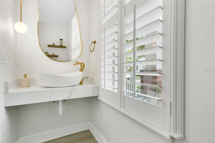 Stylish powder bath tucked away by staircase