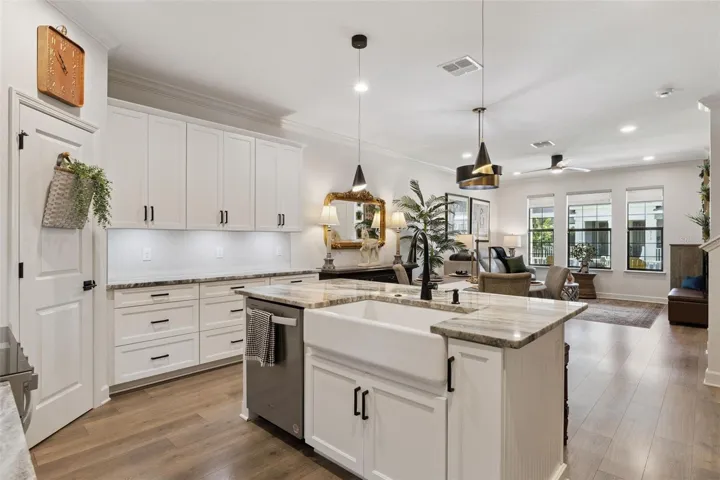 Great shot at the expansive, yet inviting open floor plan that seamlessly connects the downstairs areas, perfect for entertainment or relaxing in your home.