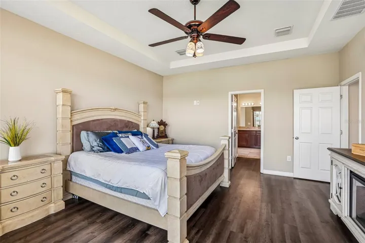 Primary Bedroom with new laminate flooring, view to the back yard and pond