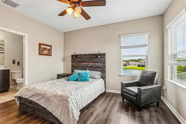 Bedroom 4 with new laminate flooring, walk in closet and ensuite bathroom