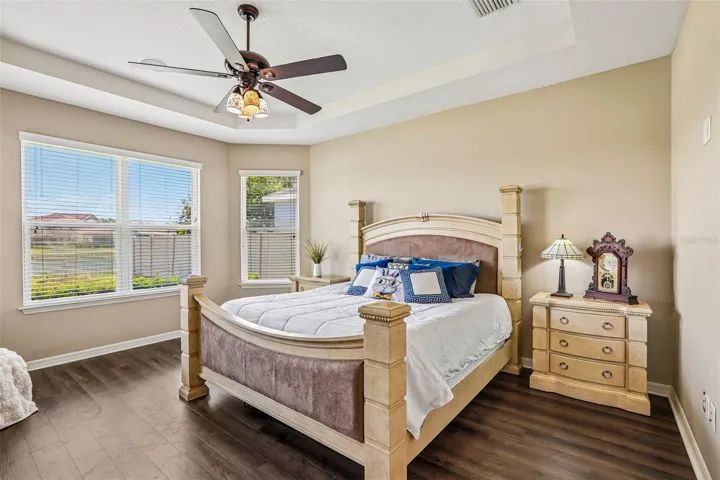 Primary Bedroom with new laminate flooring, view to the back yard and pond