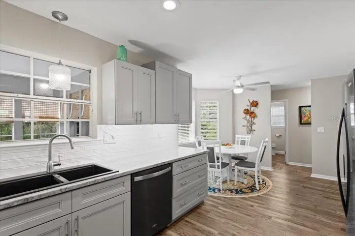 Luxury kitchen with stone counters, top of line appliances and tall wood cabinetry.